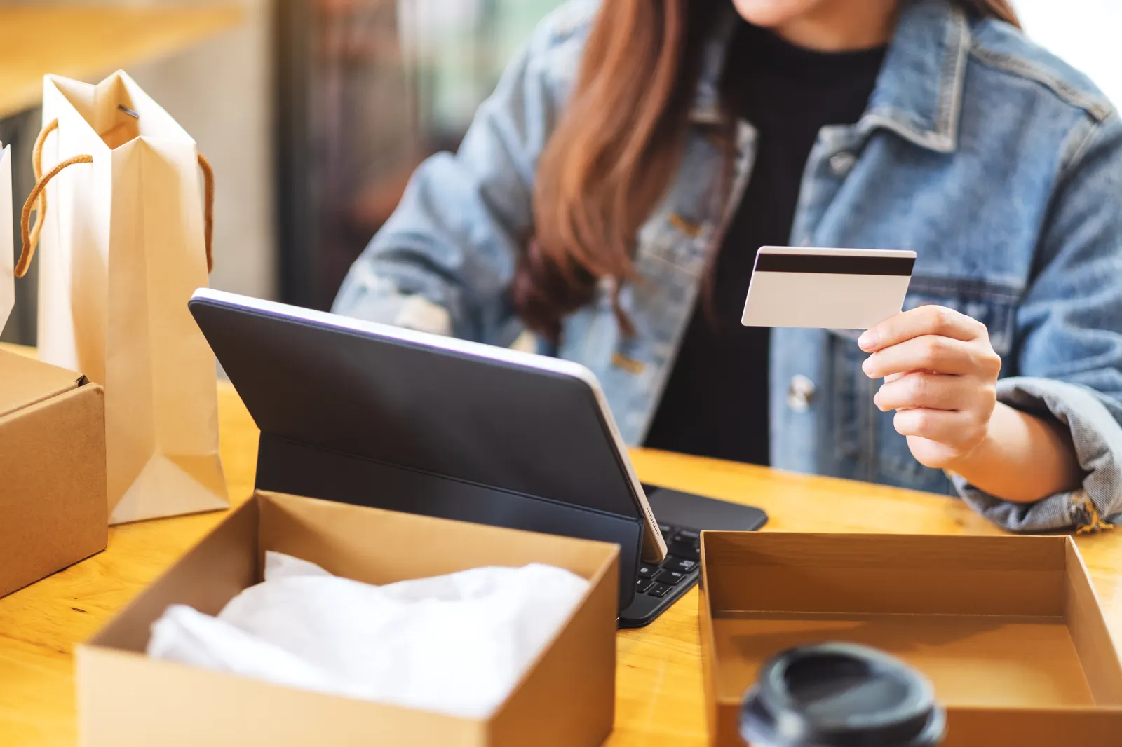 Woman shopping online from home with a credit card